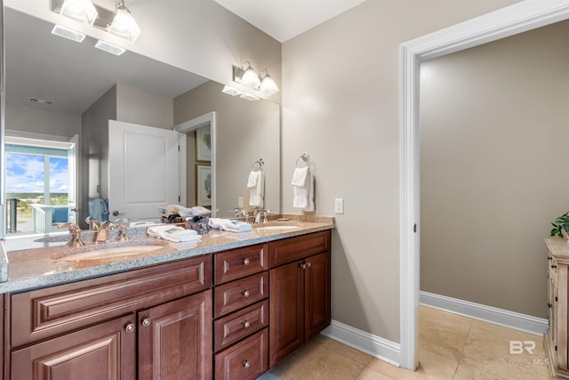 full bathroom featuring double vanity, visible vents, baseboards, tile patterned flooring, and a sink
