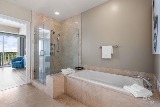 full bath with a stall shower, a bath, and tile patterned floors