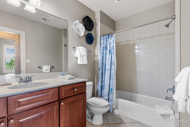 full bath with toilet, visible vents, vanity, tile patterned floors, and shower / bath combination with curtain