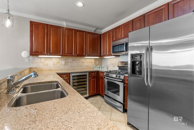 kitchen featuring beverage cooler, stainless steel appliances, a sink, ornamental molding, and pendant lighting