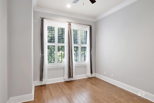 spare room with ceiling fan, ornamental molding, and light hardwood / wood-style flooring