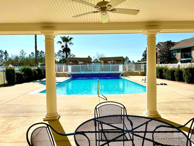 view of swimming pool with ceiling fan and a patio area