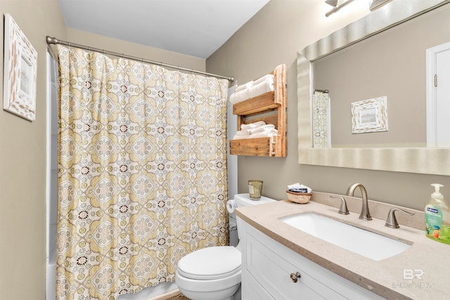 bathroom featuring vanity, toilet, and a shower with shower curtain