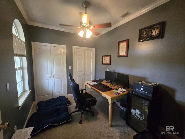 office with crown molding, ceiling fan, carpet, and visible vents