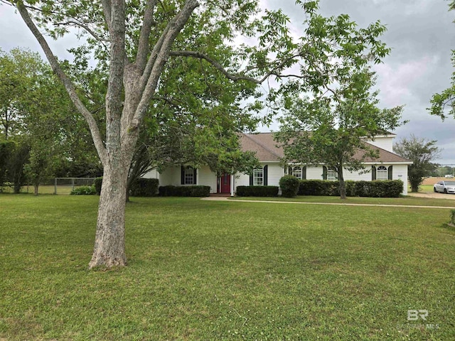 obstructed view of property featuring fence and a front yard