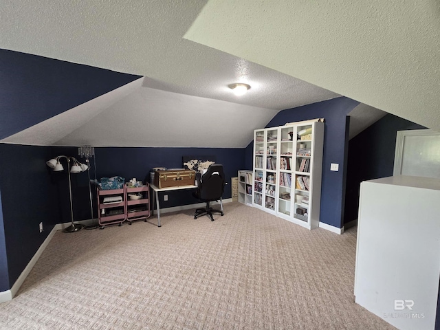 office space featuring a textured ceiling, vaulted ceiling, carpet, and baseboards