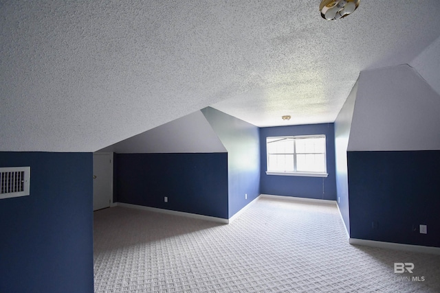 11151 Colvin Ln, Daphne, AL 36526 - additional living space featuring a textured ceiling, baseboards, carpet floors, and vaulted ceiling
