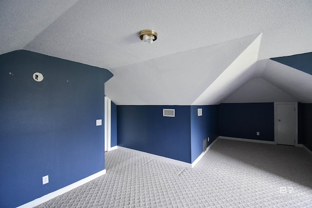11151 Colvin Ln, Daphne, AL 36526 - bonus room featuring lofted ceiling, baseboards, carpet floors, and a textured ceiling