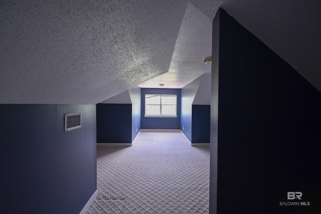 11151 Colvin Ln, Daphne, AL 36526 - additional living space with a textured ceiling, baseboards, carpet, and lofted ceiling