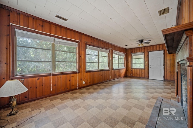 unfurnished sunroom with ceiling fan