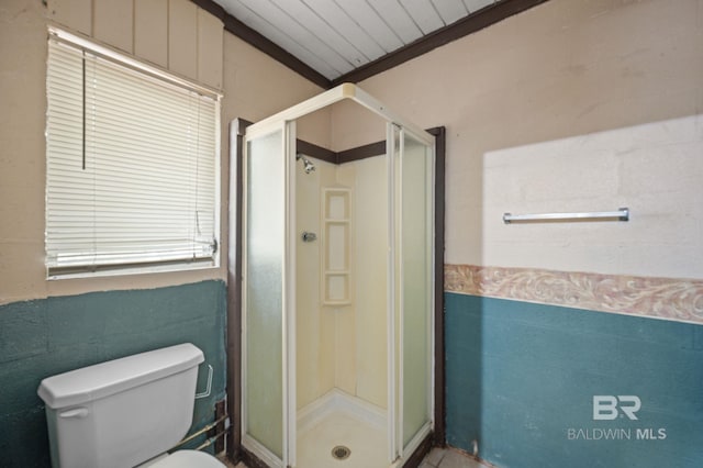 bathroom featuring toilet and an enclosed shower