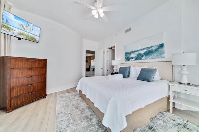 bedroom with light wood finished floors, visible vents, ceiling fan, and baseboards