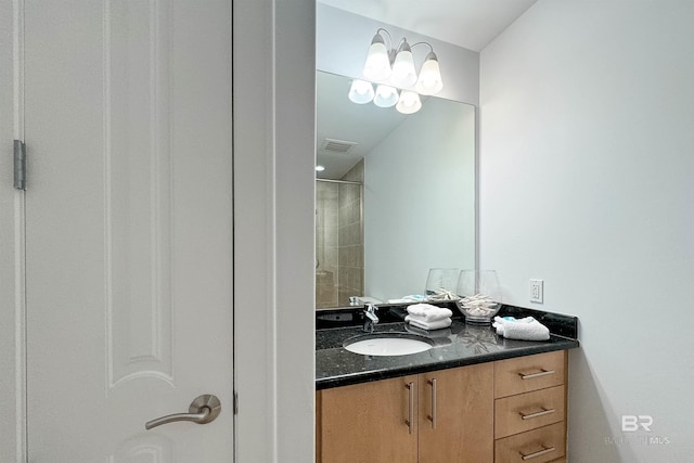 full bath featuring visible vents, vanity, and walk in shower