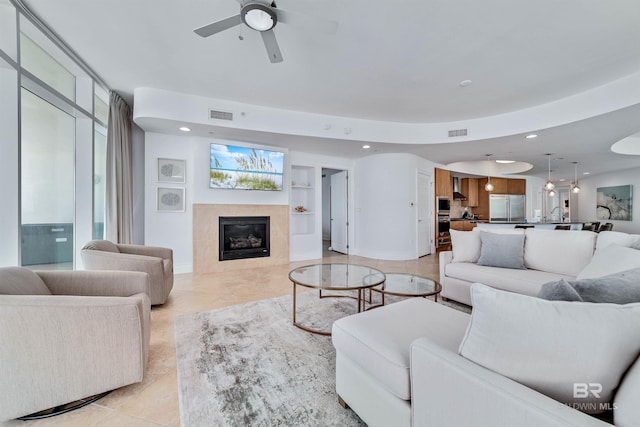 living area with visible vents, recessed lighting, a fireplace, and baseboards