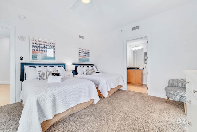 bedroom featuring visible vents, ensuite bath, a ceiling fan, and carpet floors