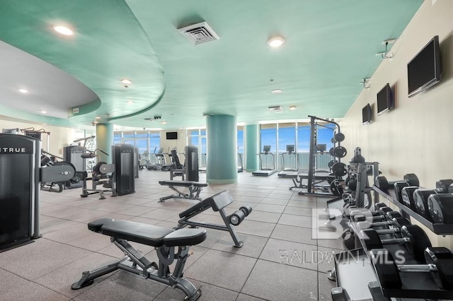 gym featuring a wealth of natural light, visible vents, and expansive windows