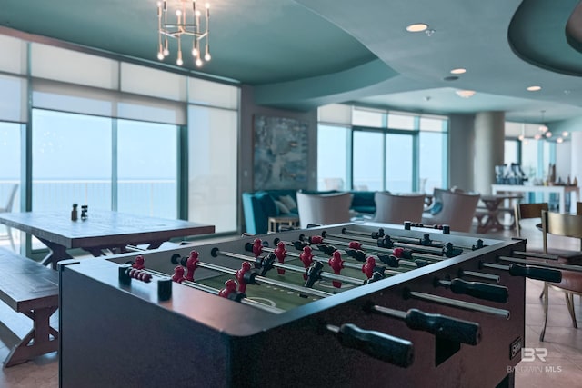 recreation room with recessed lighting, a chandelier, and tile patterned floors