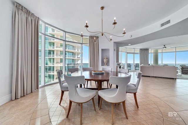 dining room with a wall of windows, light tile patterned floors, and a chandelier