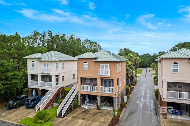 view of front of house with a balcony and a carport