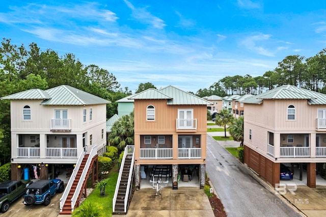 view of front of property featuring a balcony and a carport