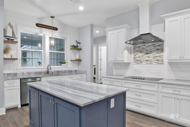 kitchen with wall chimney range hood, sink, stainless steel dishwasher, black electric cooktop, and white cabinetry