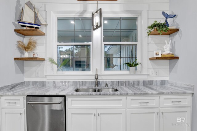 bar featuring dishwasher, light stone counters, white cabinetry, and sink