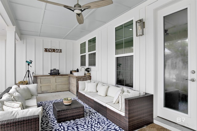 sunroom / solarium featuring ceiling fan