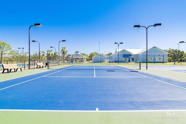 view of tennis court featuring basketball hoop