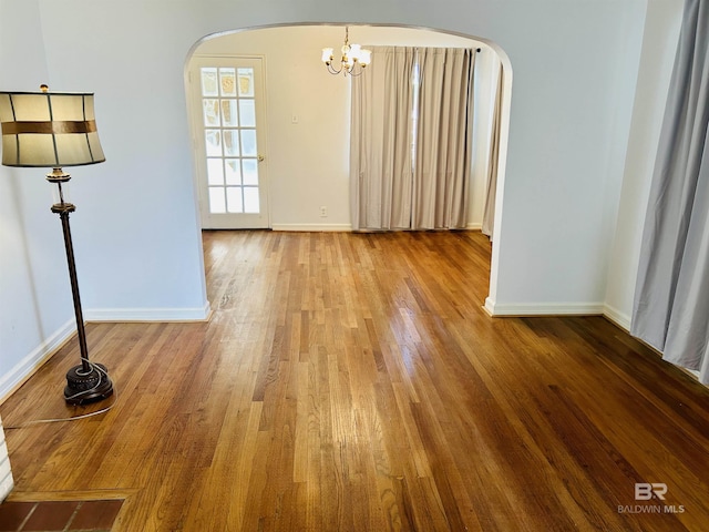 unfurnished room with wood-type flooring