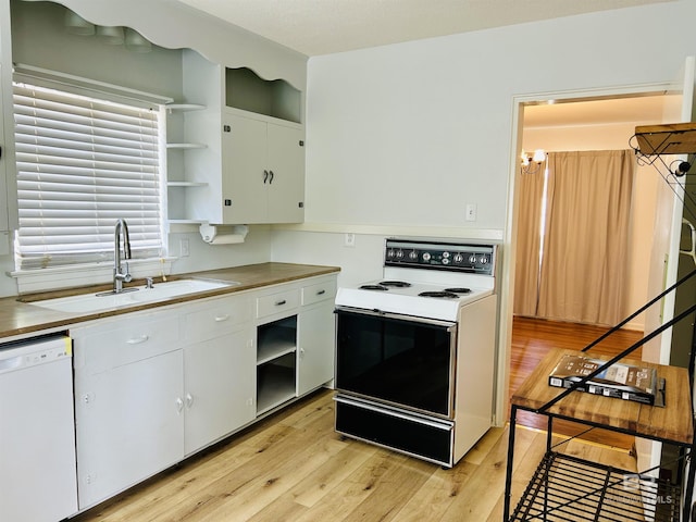 kitchen featuring white appliances, sink, light hardwood / wood-style flooring, and white cabinets