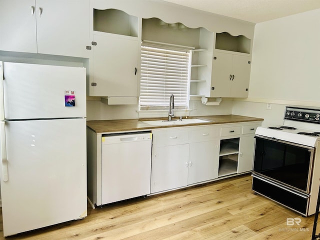 kitchen featuring sink, white cabinets, white appliances, and light hardwood / wood-style floors