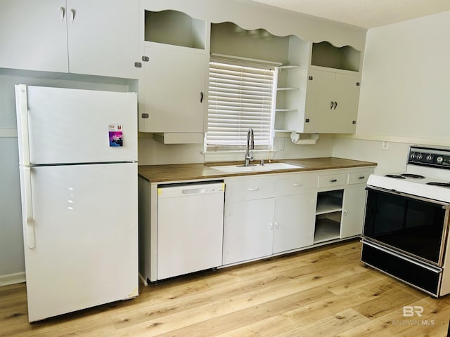 kitchen featuring sink, white cabinets, white appliances, and light hardwood / wood-style floors