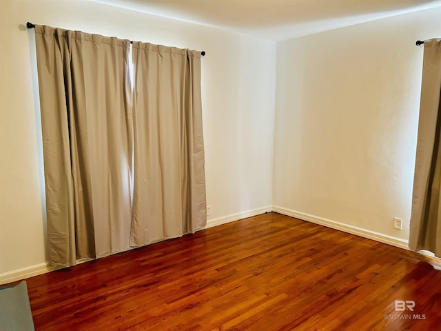 unfurnished room featuring hardwood / wood-style flooring