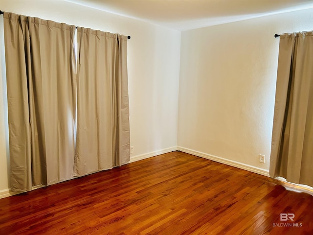 unfurnished room featuring hardwood / wood-style flooring