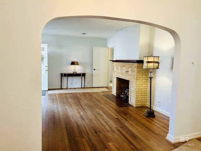 unfurnished living room featuring hardwood / wood-style floors and a fireplace