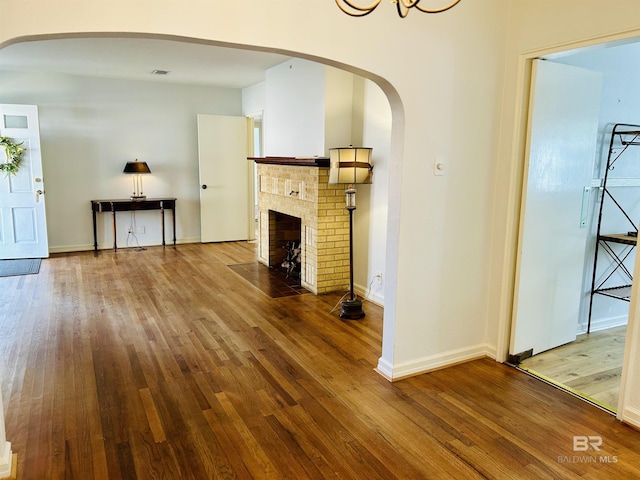 unfurnished living room with wood-type flooring and a fireplace