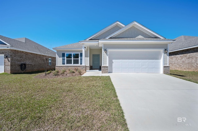 view of front of property featuring a front yard, driveway, and an attached garage