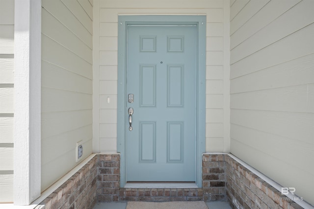 property entrance with stone siding