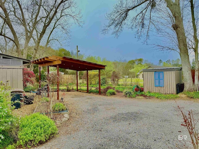 exterior space with a storage shed, an outbuilding, and driveway