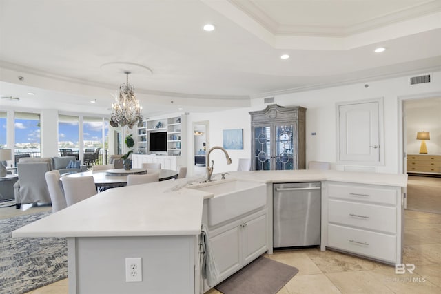 kitchen featuring visible vents, crown molding, open floor plan, dishwasher, and a sink