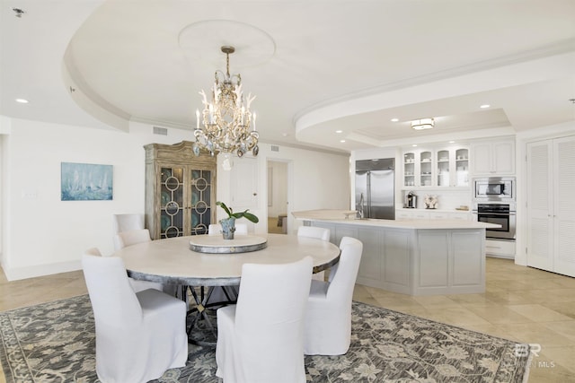 dining room featuring a tray ceiling, light tile patterned flooring, recessed lighting, ornamental molding, and a chandelier