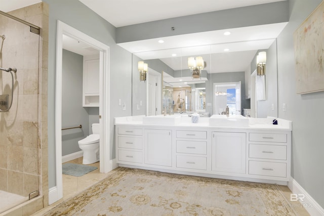 full bath featuring double vanity, a shower stall, and a sink