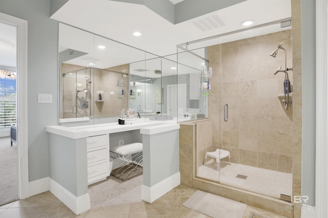 full bathroom with tile patterned floors, visible vents, a stall shower, baseboards, and vanity