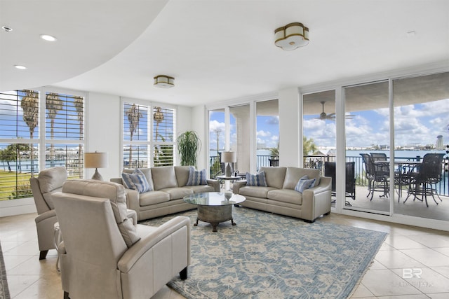 living area featuring a wall of windows, light tile patterned floors, and recessed lighting