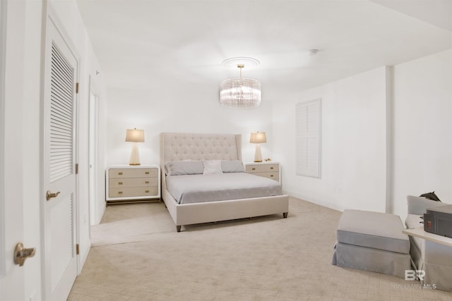 carpeted bedroom with an inviting chandelier