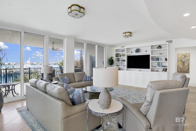 living area featuring light tile patterned flooring, floor to ceiling windows, recessed lighting, and built in shelves