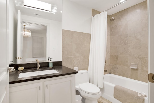 bathroom featuring vanity, shower / bath combo with shower curtain, toilet, and visible vents