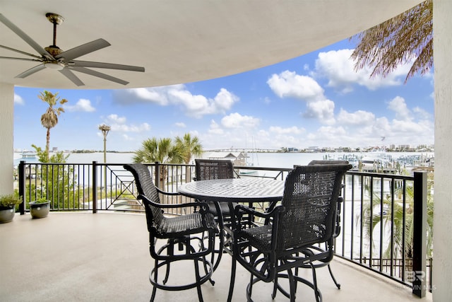 balcony featuring a water view and ceiling fan