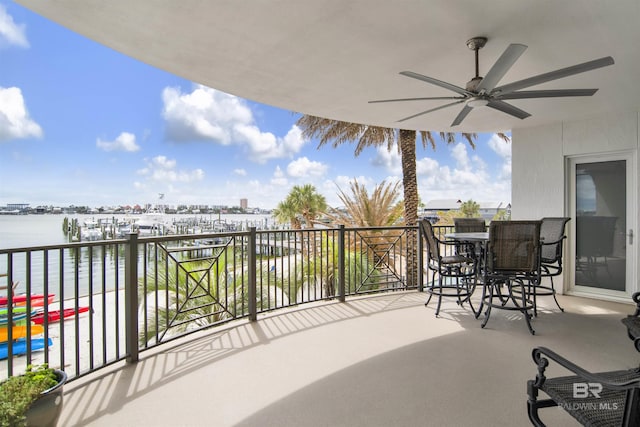 balcony featuring a water view and ceiling fan