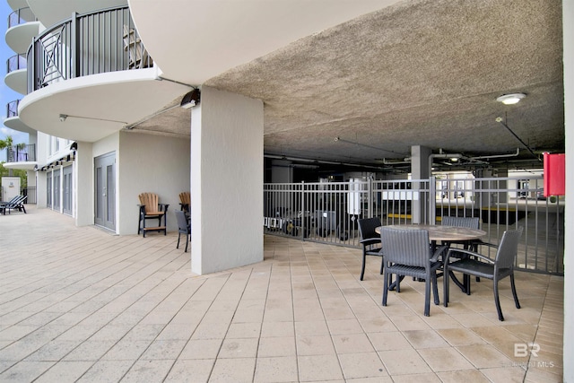 view of patio featuring a balcony and outdoor dining space